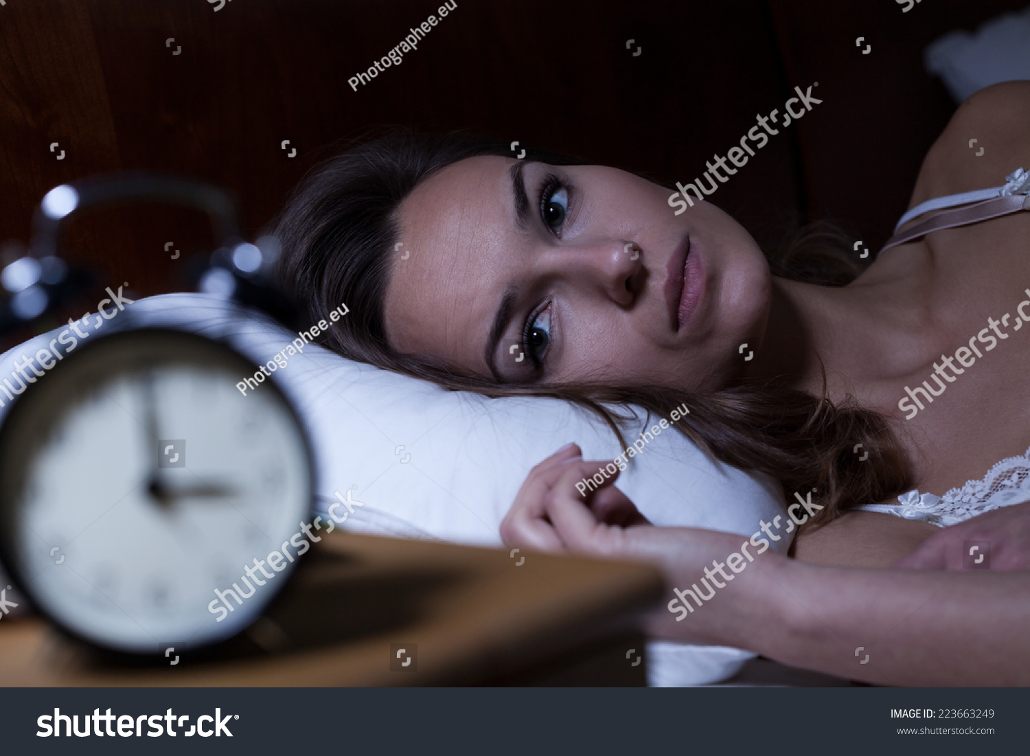 Woman lying in bed suffering from insomnia #223663249