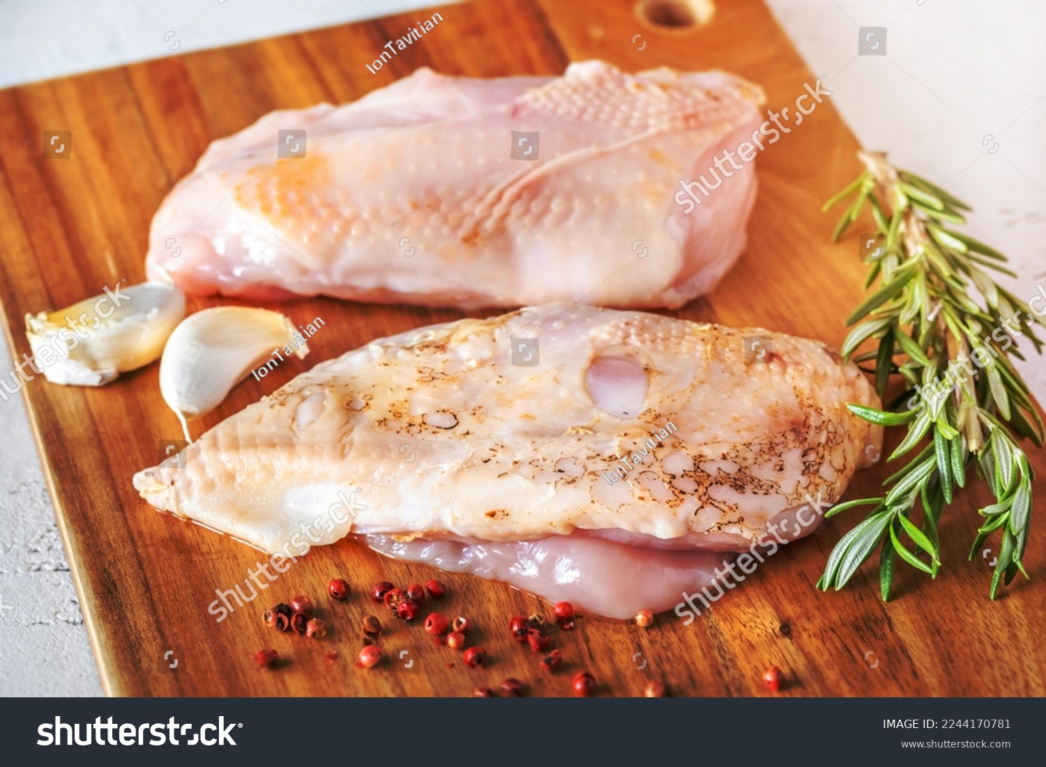Uncooked chicken breast on the cutting board #2244170781