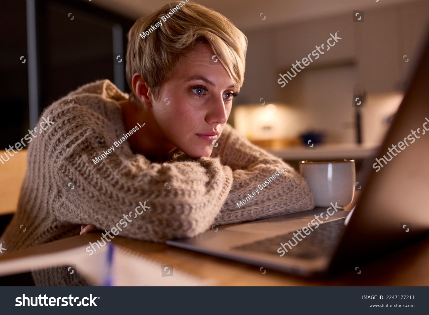 Young Woman Working Or Studying On Laptop At Home At Night Staring At Screen #2247177211