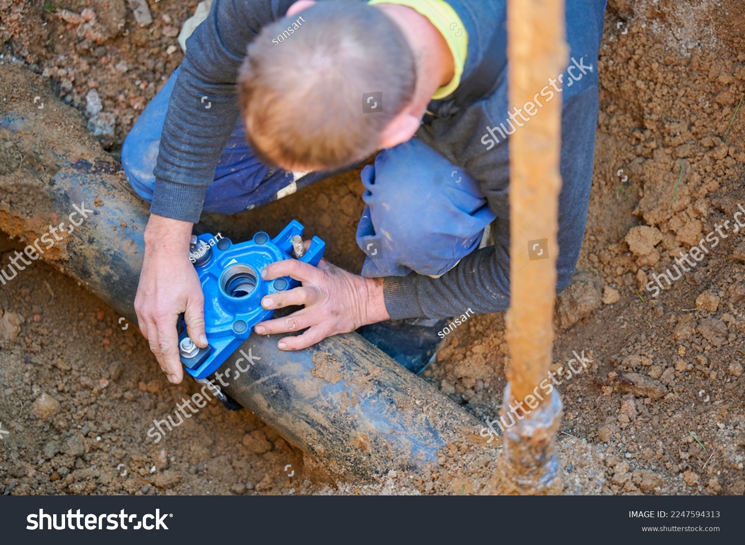 Construction worker, repairing a broken water pipe.
Construction site with new Water Pipes in the ground. Plumber work repair water line connect. #2247594313