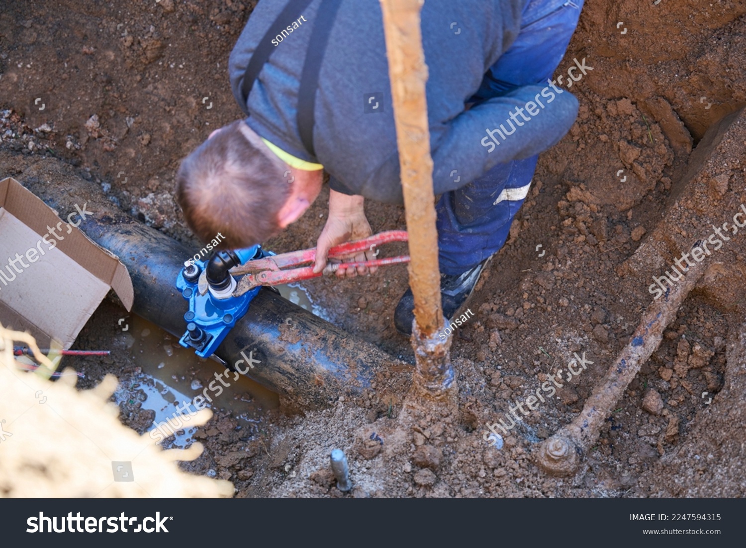 Construction worker, repairing a broken water pipe.
Construction site with new Water Pipes in the ground. Plumber work repair water line connect. #2247594315