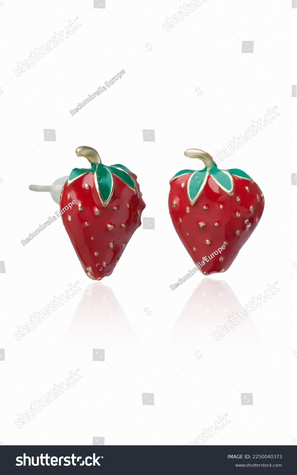 Subject shot of golden stud earrings made as strawberries decorated with bright colored enamel. The original earrings are isolated on the white background. Vogue accessory for ladies and girls. #2250040373