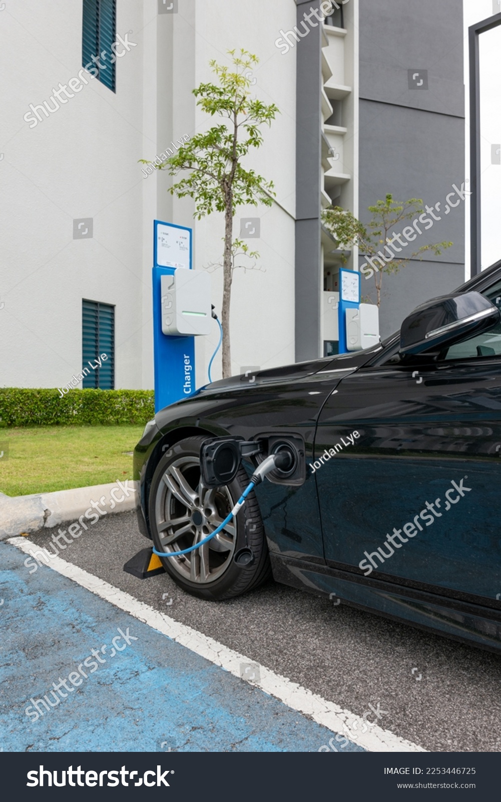 Electric automobile loading, plugged into charging station. #2253446725