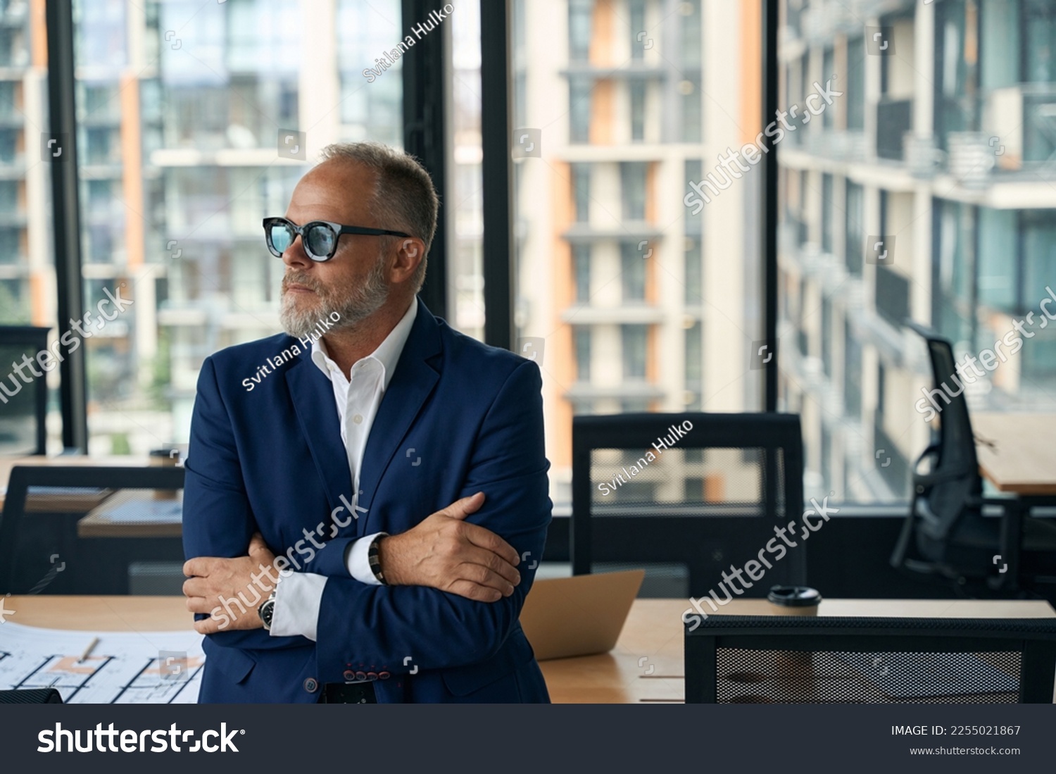 Serious male entrepreneur posing at office with arms crossed #2255021867