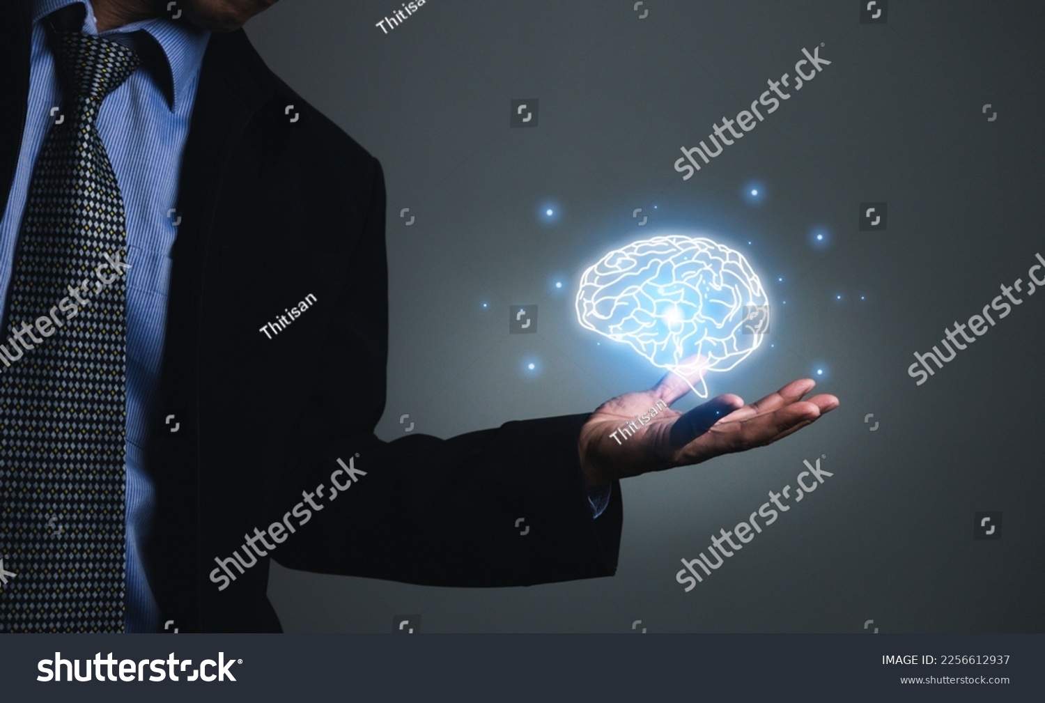 Close-up of businessman's hand holding brain in palm, Virtual reality man with symbol neurons in the brain. Concept of idea and innovation, business concept. #2256612937