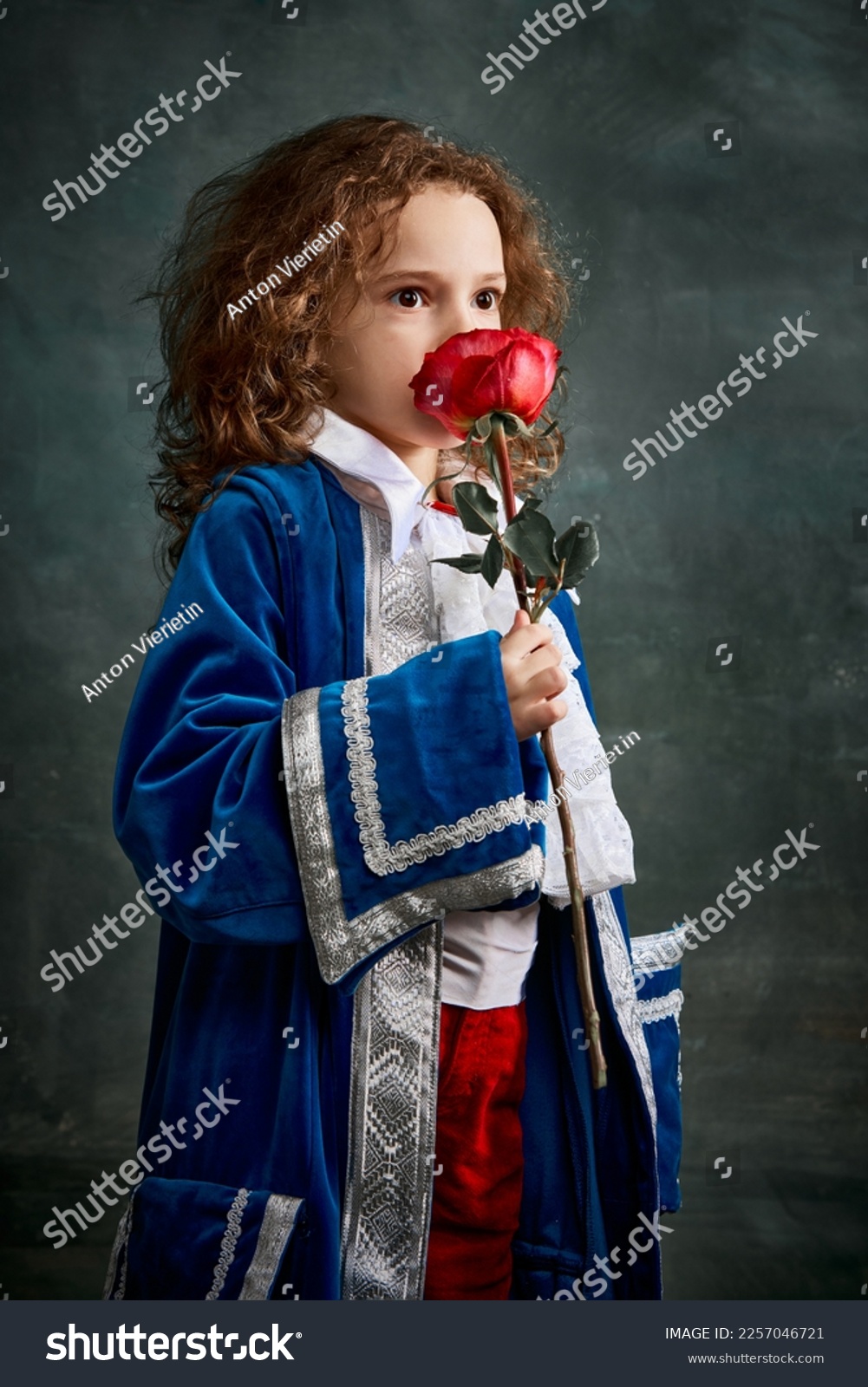 Cinematic portair of beautiful little girl dressed up as medieval knight, little prince over dark vintage style background, Fashion, beauty, emotions, theater concept. Eras comparison #2257046721