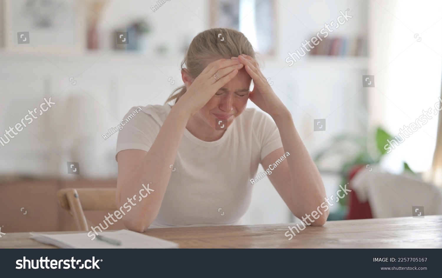Upset Young Woman Feeling Worried While Sitting in Office #2257705167