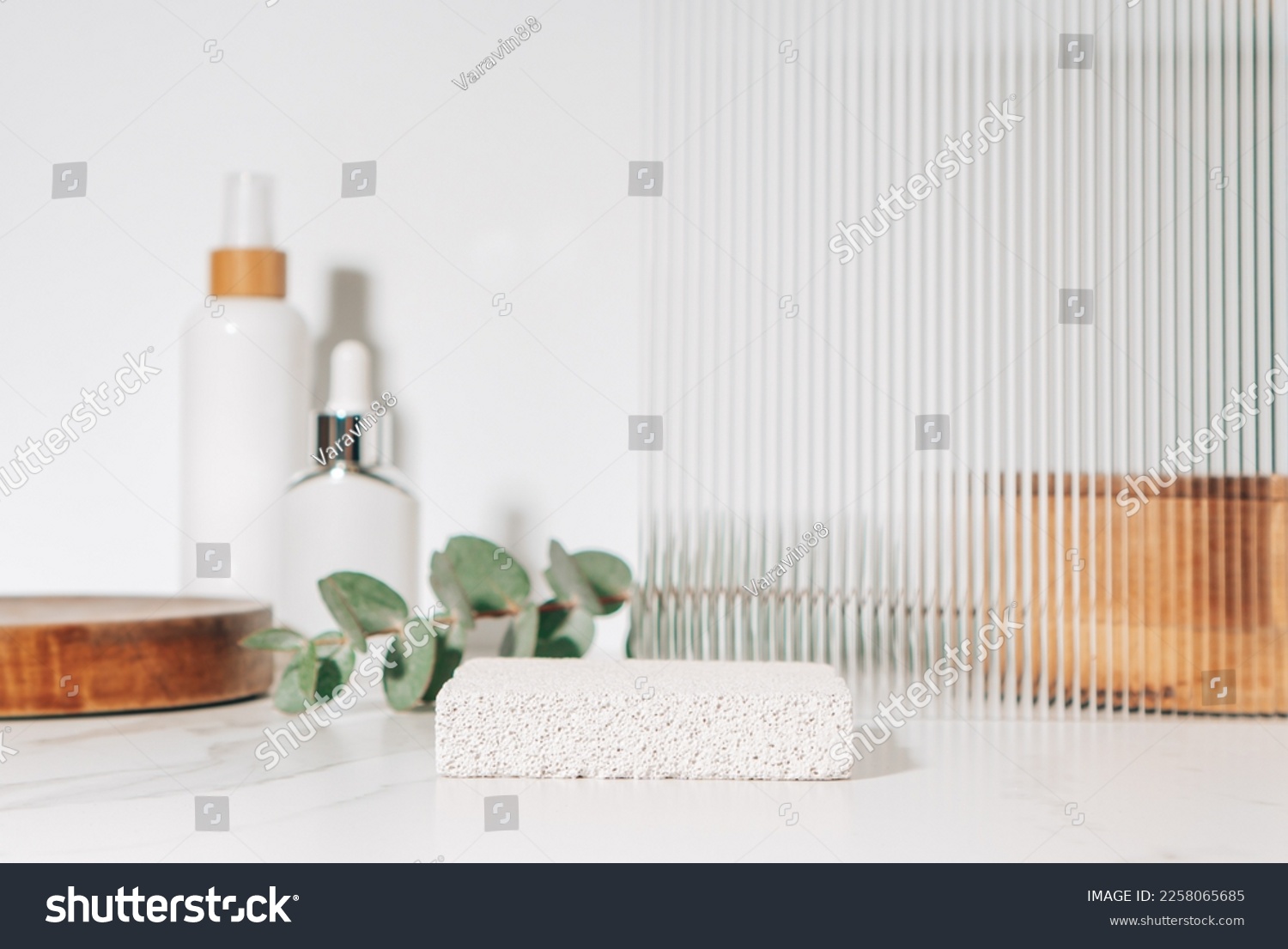 Spa and beauty product presentation scene made with porous stone podium near the cosmetic tubes and accessories on white bathroom shelf. #2258065685