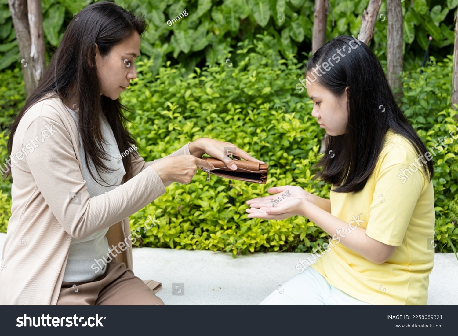 Poor family of single mother and teen daughter having no money, struggling with economic crisis, unemployment, inflation with empty purse #2258089321
