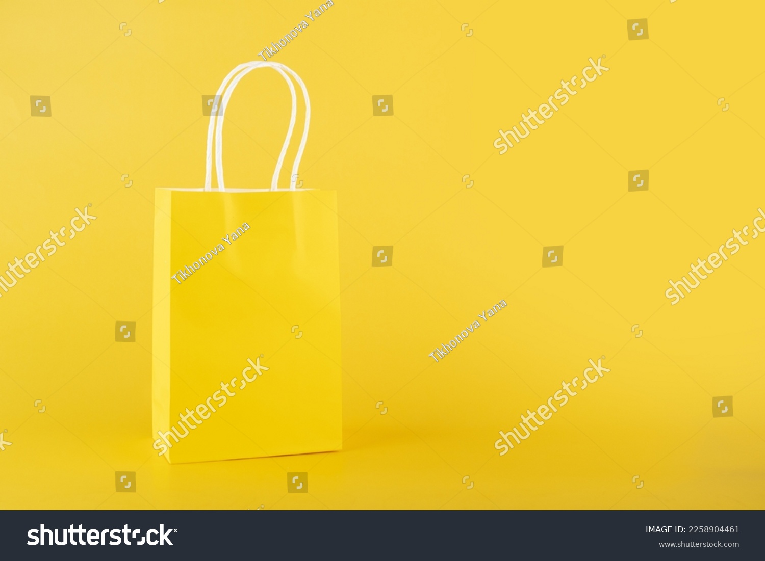 shopping bag on yellow background, copy space, monochrome,one color  #2258904461