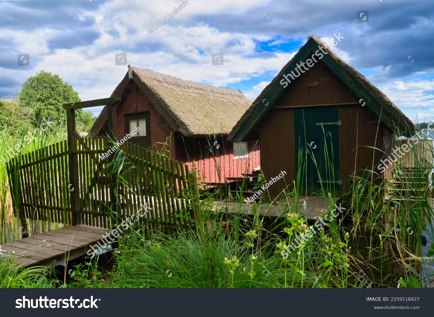 Fishing lodge on the lake near Krakow on the lake. Inland fishing. Vine roof on the house. Vacation resort in Germany. Landscape photo from nature #2259118427