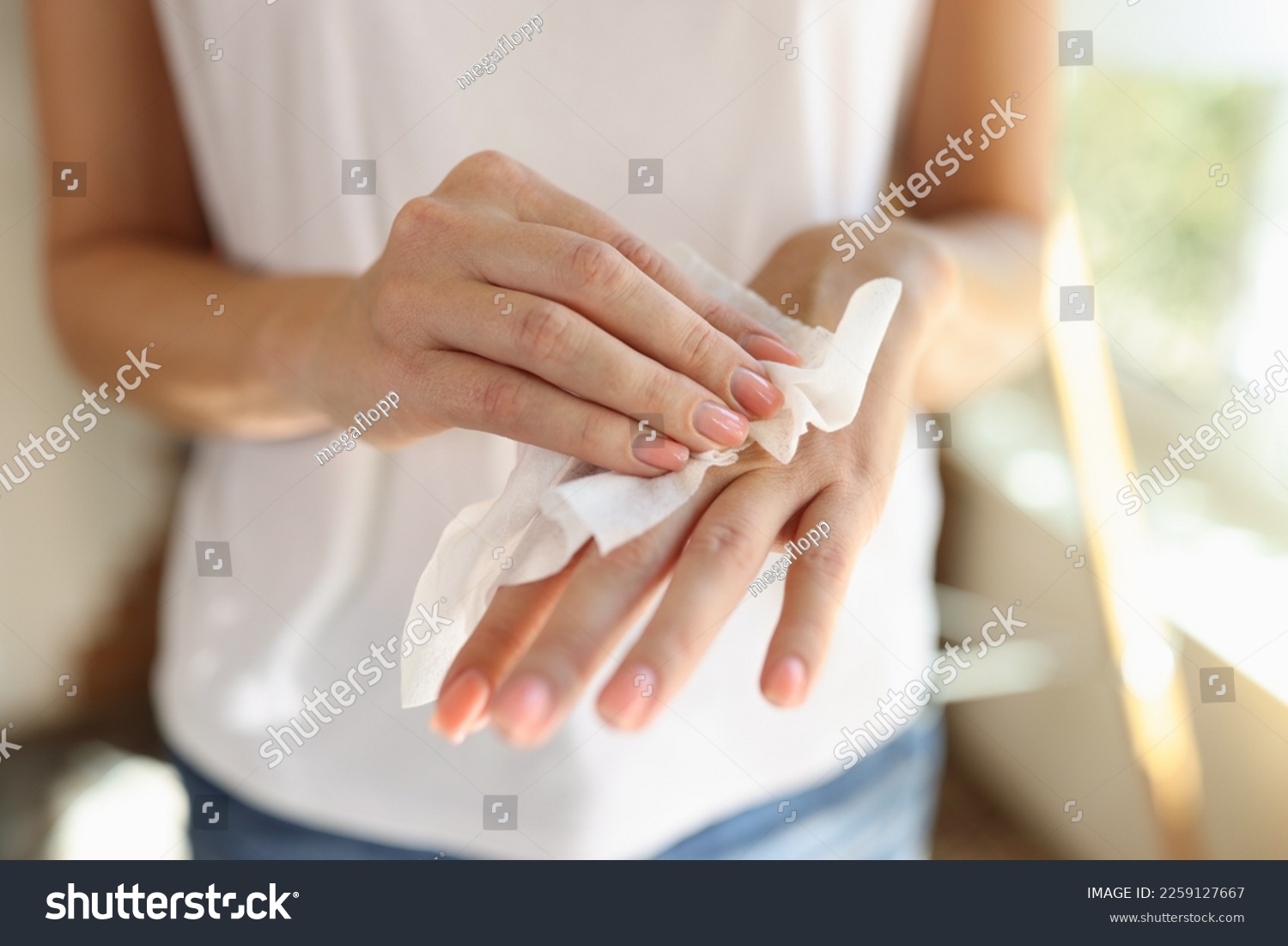 Woman cleans hand with wet wipes close up. Hygiene and skin care concept. #2259127667