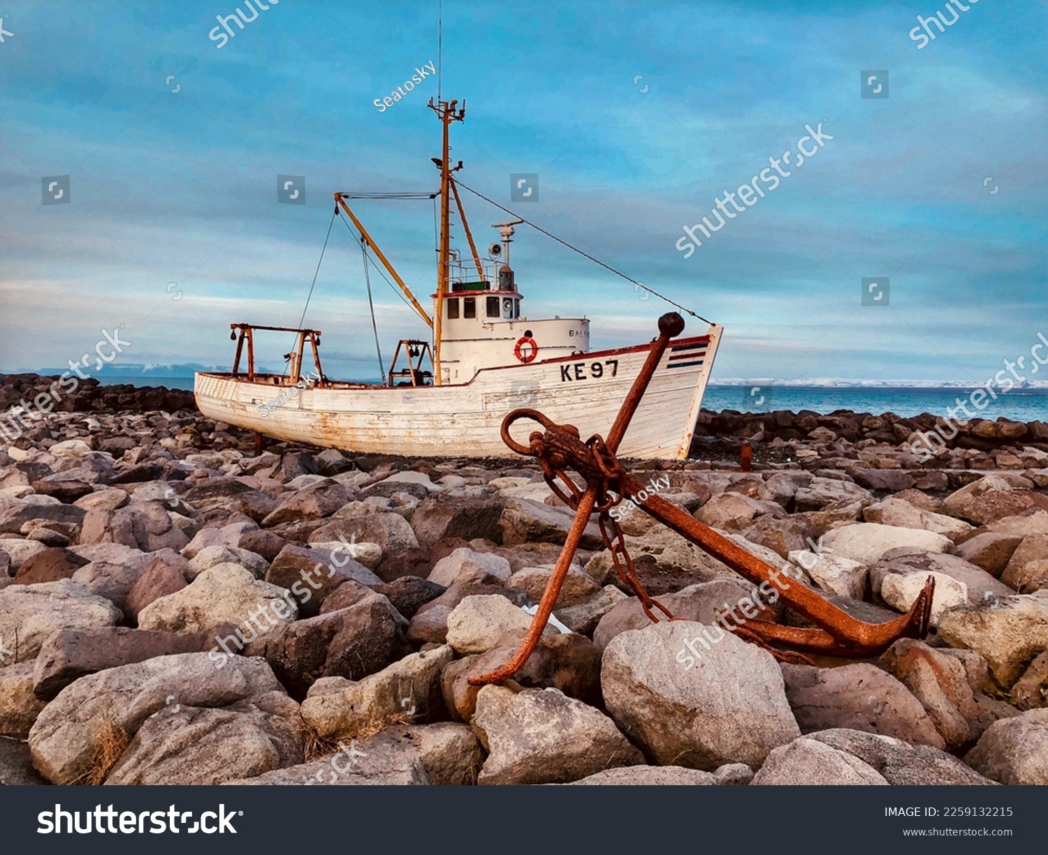 An abandoned fishing boat anchored off the coast of Iceland  #2259132215