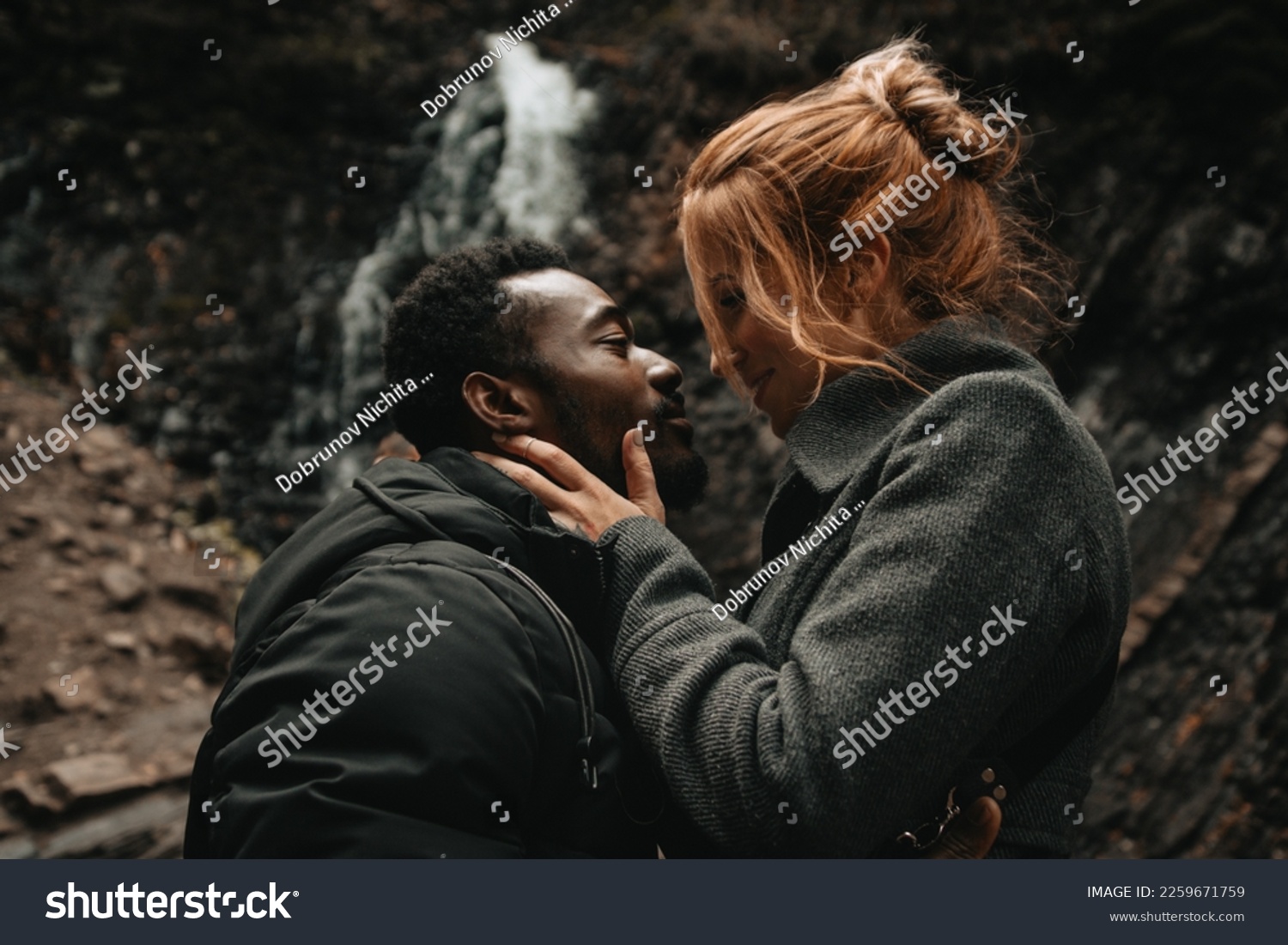 couple in love at the waterfall. couple photo session. interracial couple. waterfall in ukraine in yaremche. model photoset #2259671759