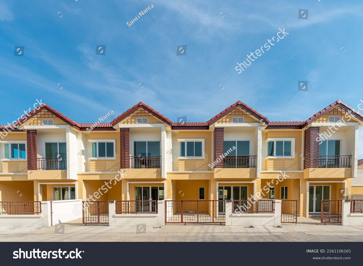 The row of just finished new yellow townhouses, Front View of New Residential house, the architectural design of the exterior with blue sky and apace,The concept for Sale, Rent,Housing,and Real Estate #2261106165