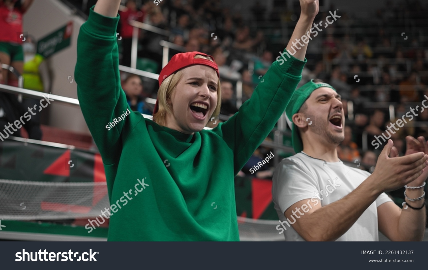 Happy fans football stadium arena. Emotion crowd clap applaud. Smile guy watch soccer cup. Man cheering sport team. Wild girl enjoy goal score. Game event stands. Win play. Fan cheer tribune close up. #2261432137