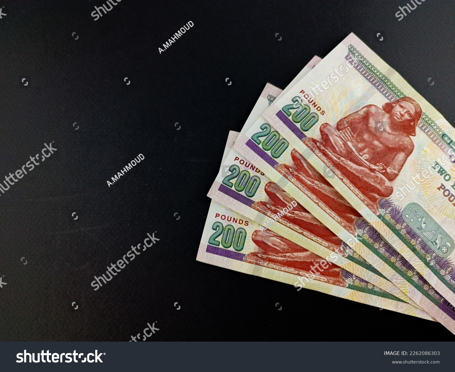 egyptian money two hundred pounds isolated on black background , close up two hundred #2262086303