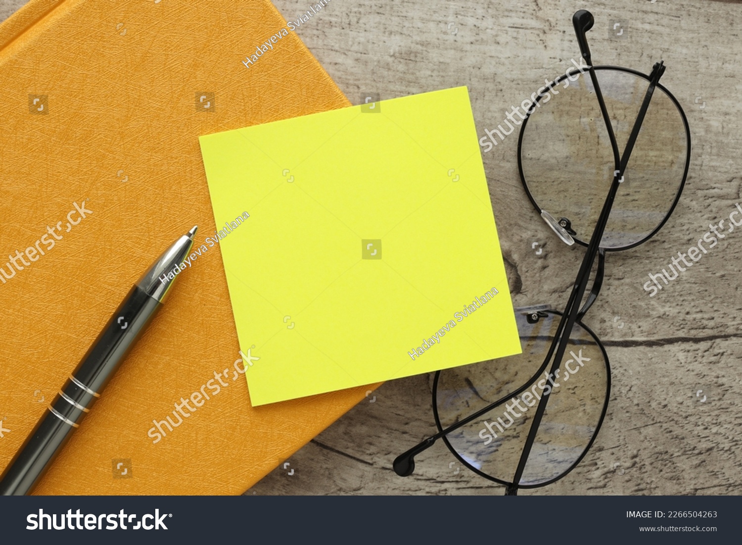 yellow reminder sticky note on a yellow notepad, empty space for text #2266504263