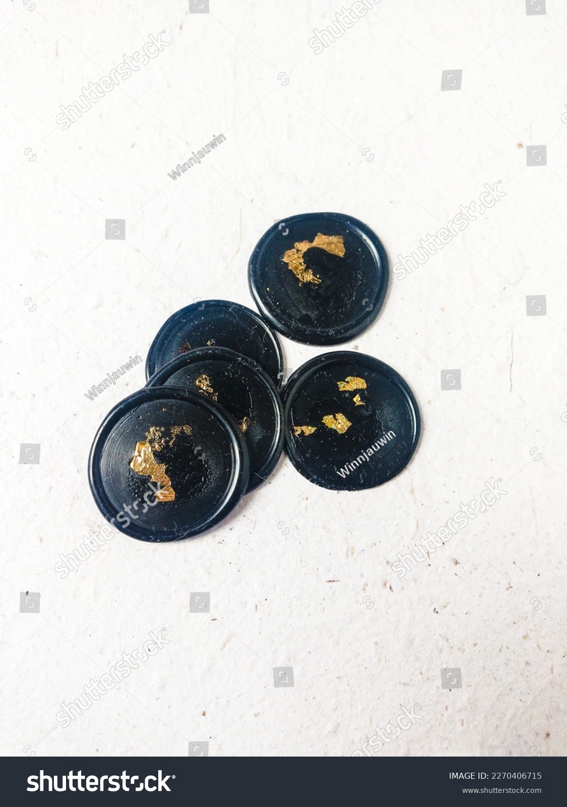 A bunch of black with gold foil blank wax stamp coins on a white background. Can be use for vintage antique wedding invitation or decoration #2270406715