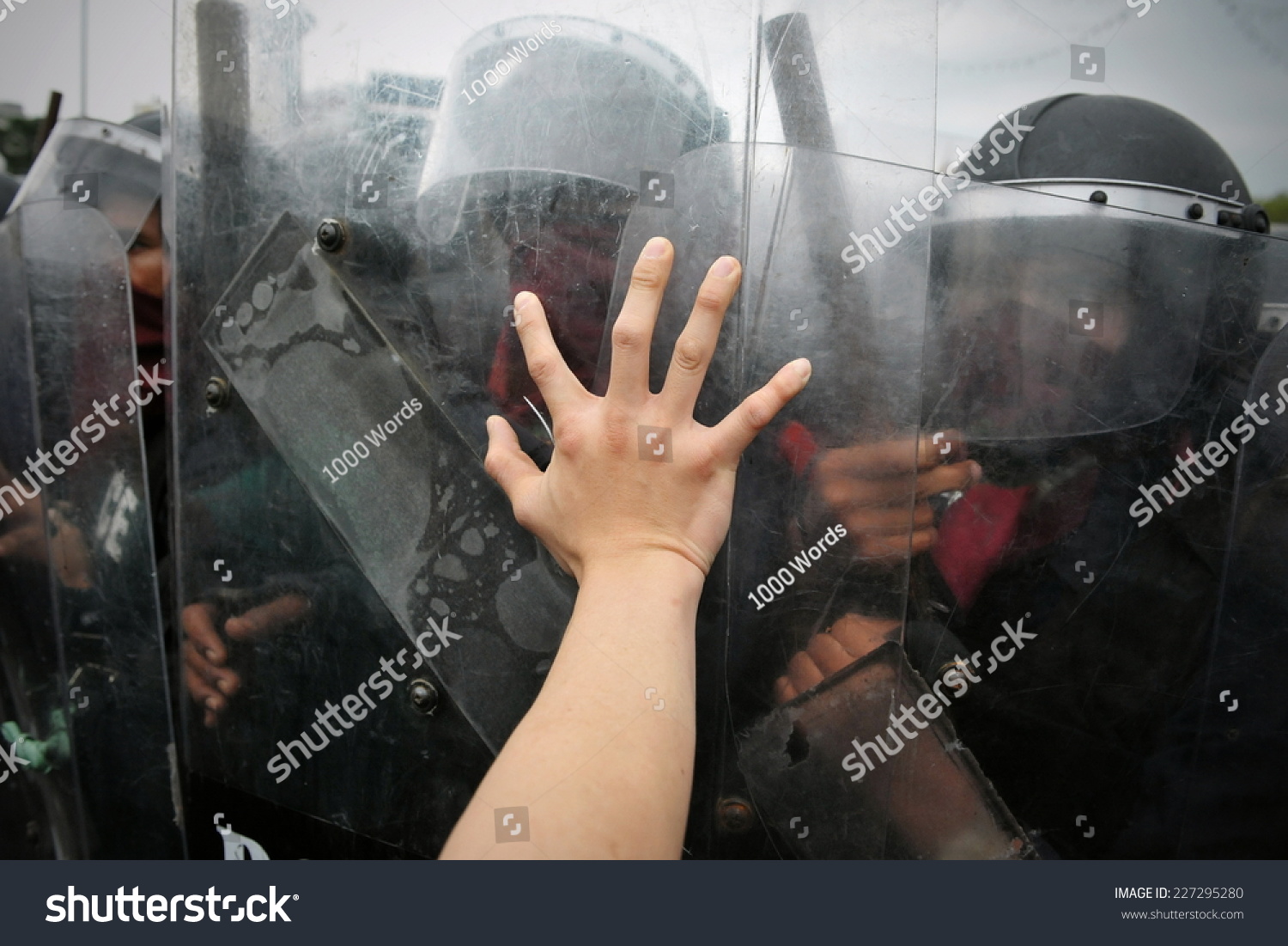 Protester Pushes Police Riot Shields at a Political Rally #227295280