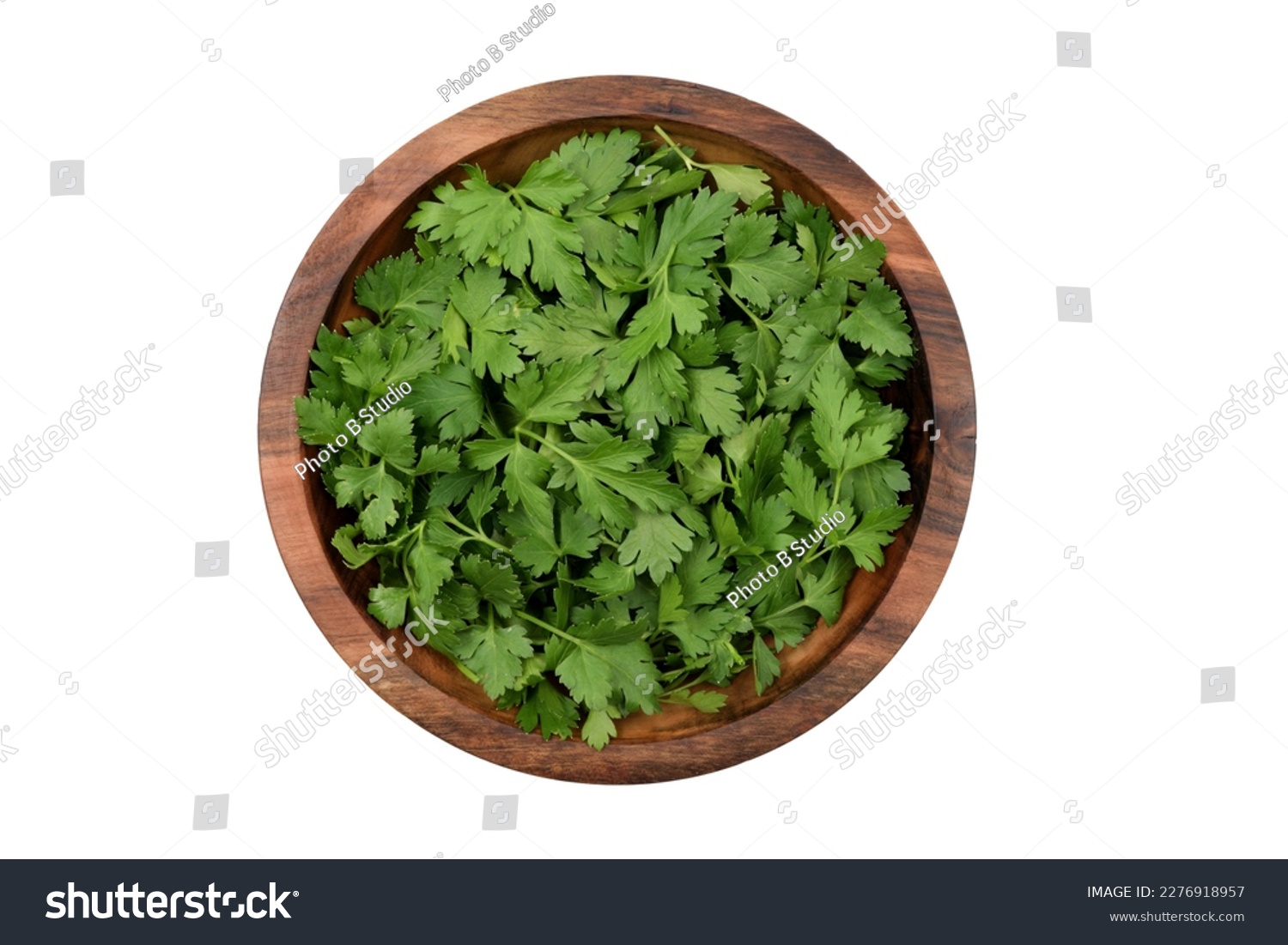 Chopped fresh parsley leaves in a wooden bowl, isolated on white background, top view #2276918957