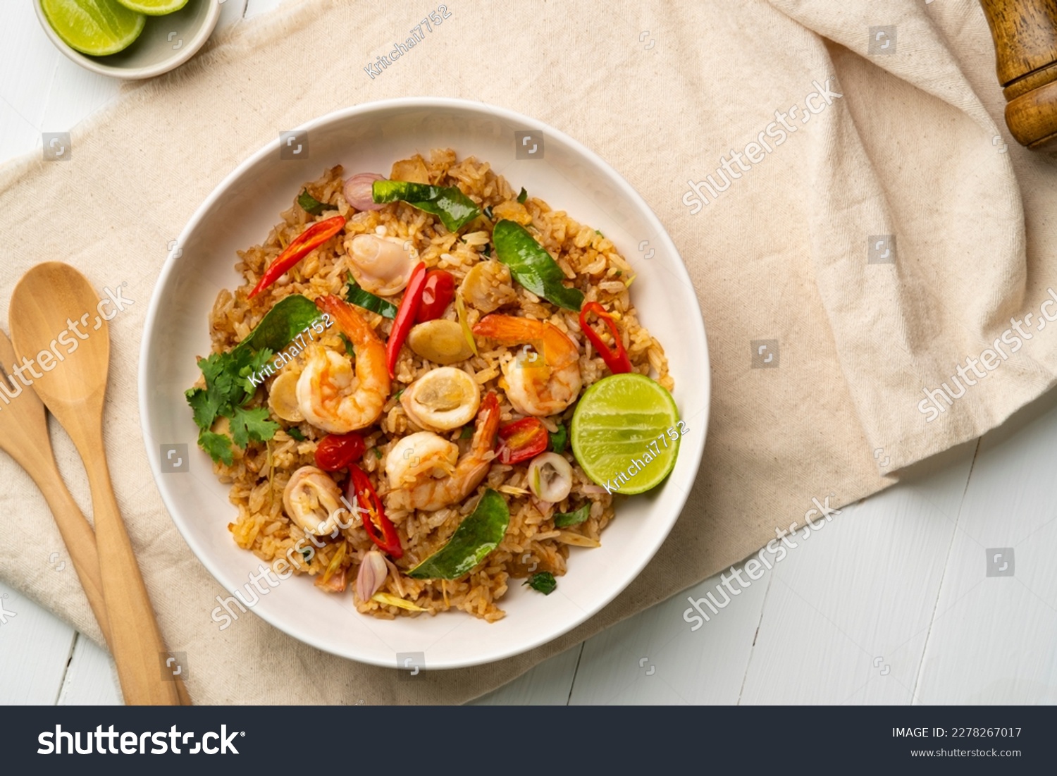 Seafood Tom Yum Fried Rice,Stir fried rice with shrimp and squid with chilli sauce on white plate.Top view #2278267017