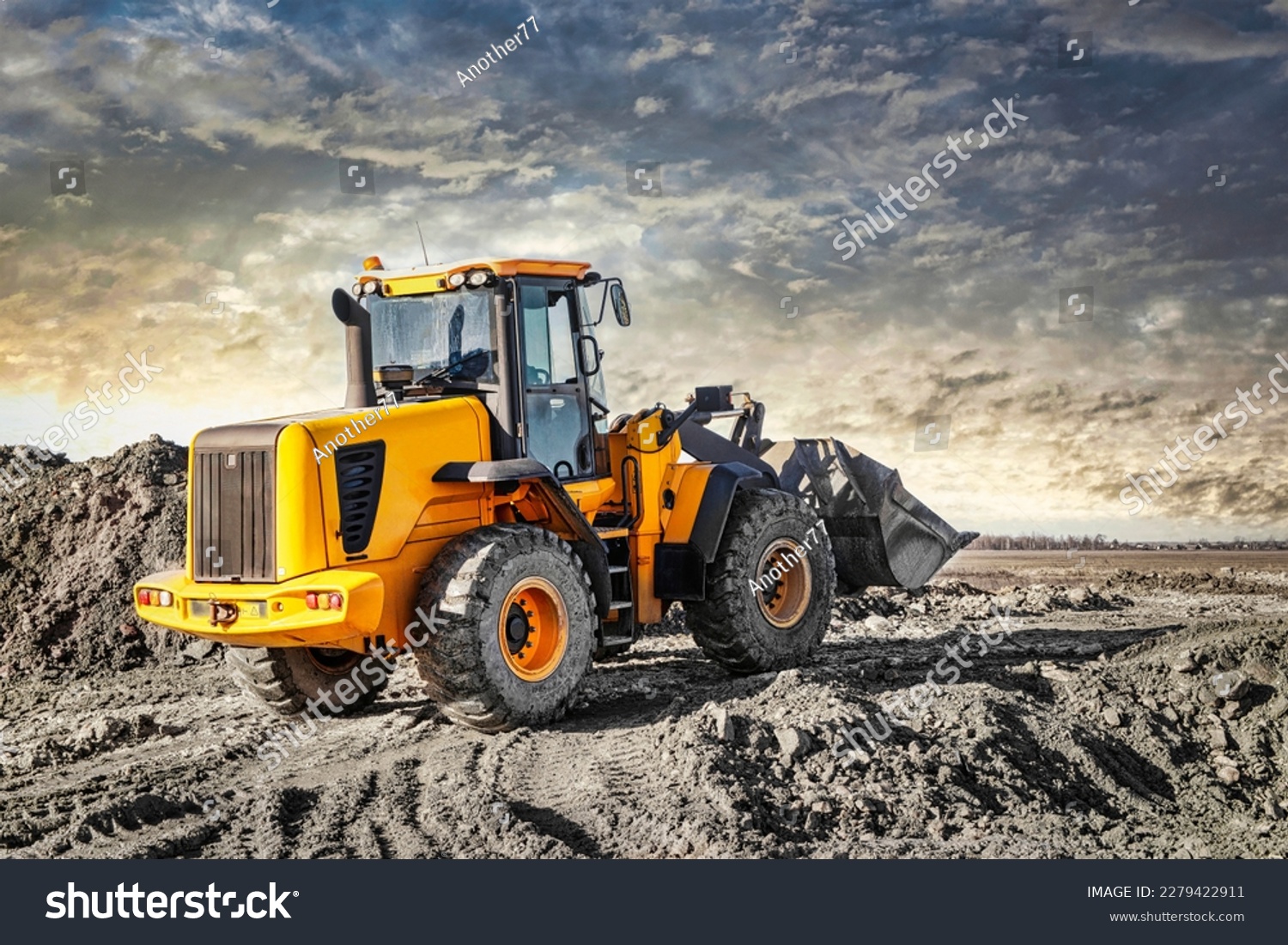 Powerful wheel loader or bulldozer working on a quarry or construction site. Earthworks in construction. Powerful modern equipment for earthworks #2279422911