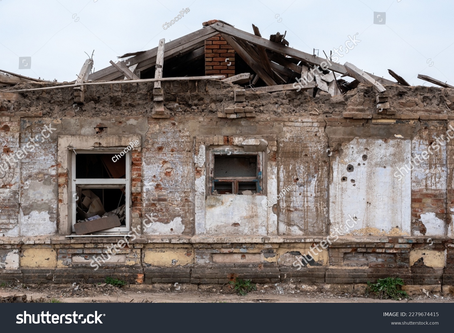 destroyed and burned houses in the city during the war in Ukraine #2279674415