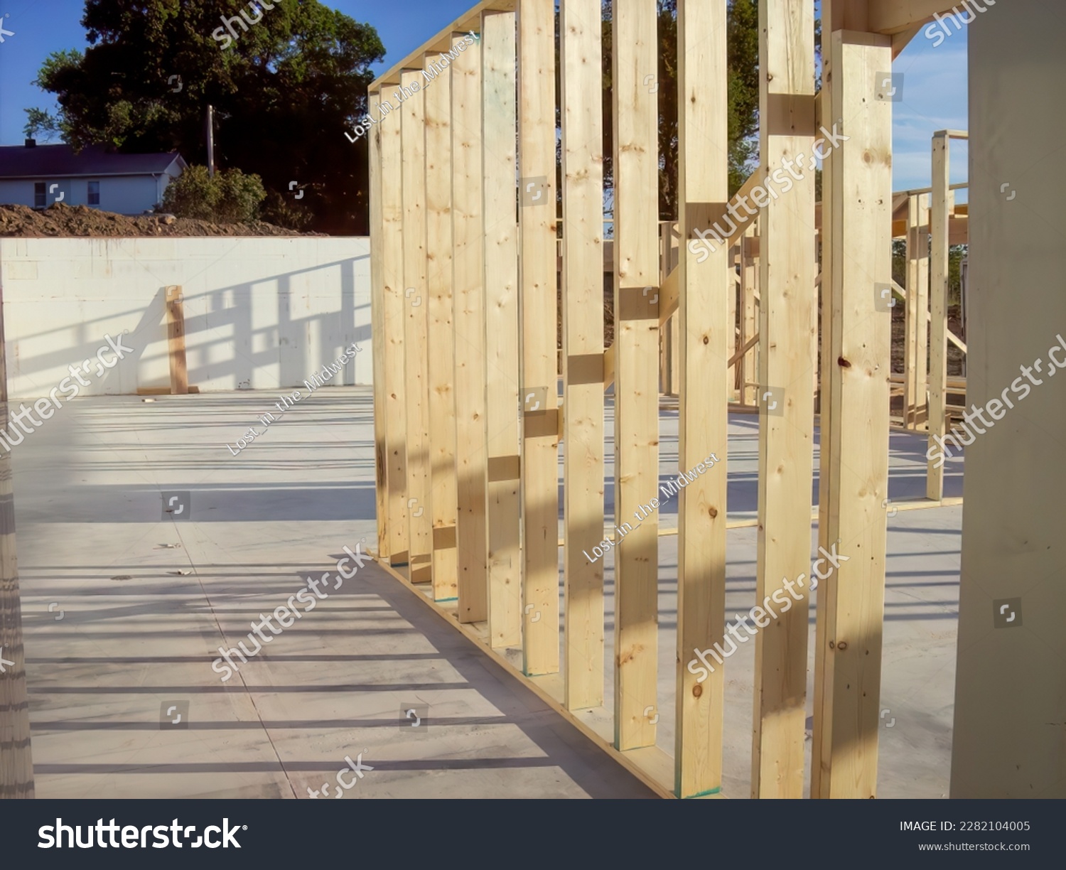 Wall frame being built on a slab-on-grade single story berm home.  #2282104005