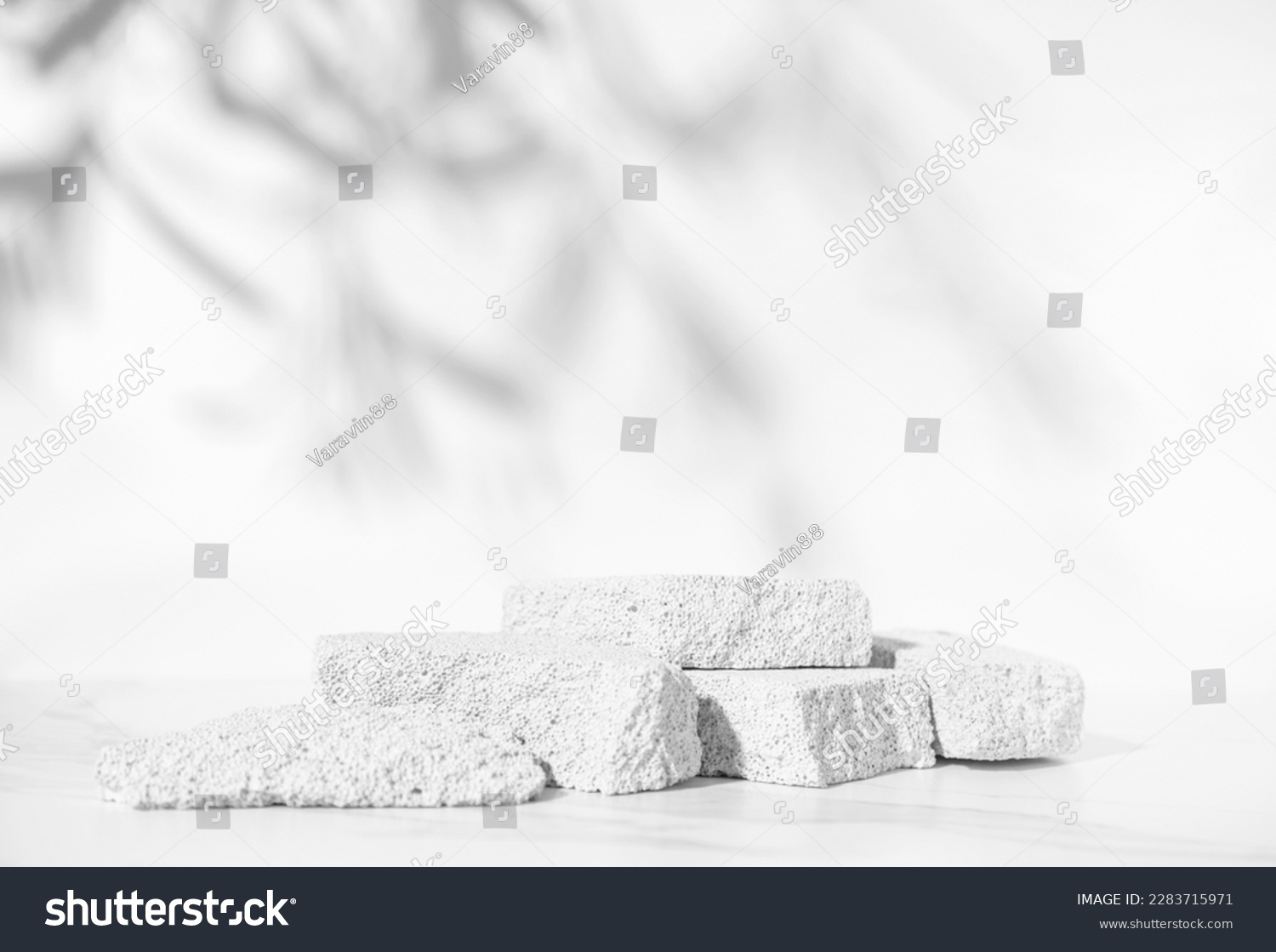 Beauty skin care product presentation podium and display with copy space made with porous stones on white sunny background. Studio photography. #2283715971