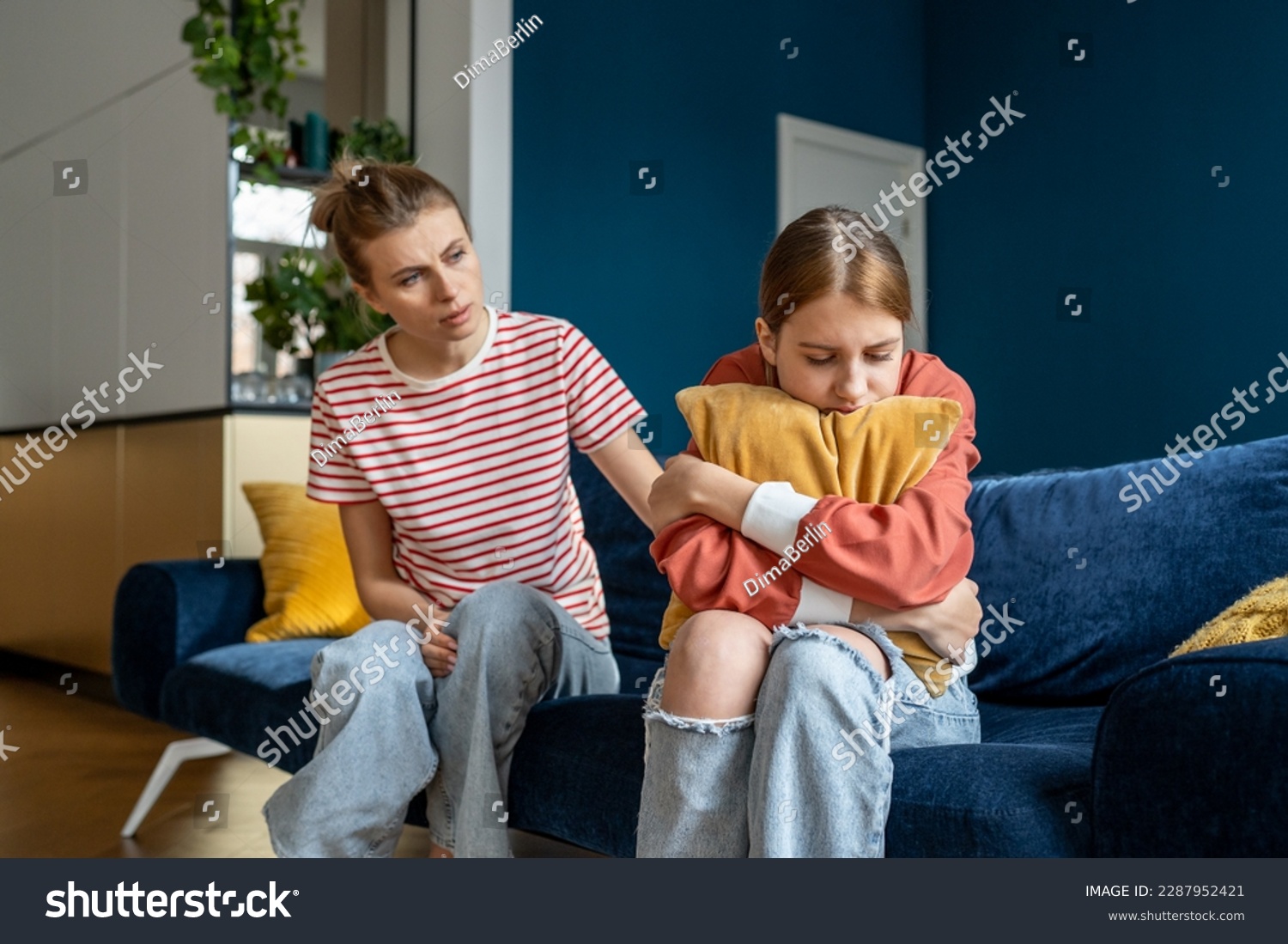 Mother supporting child upset teen girl during difficult adolescence stage, loving parent comforting child at home. Sad teenage daughter crying and feel anxious, being bullied at school #2287952421
