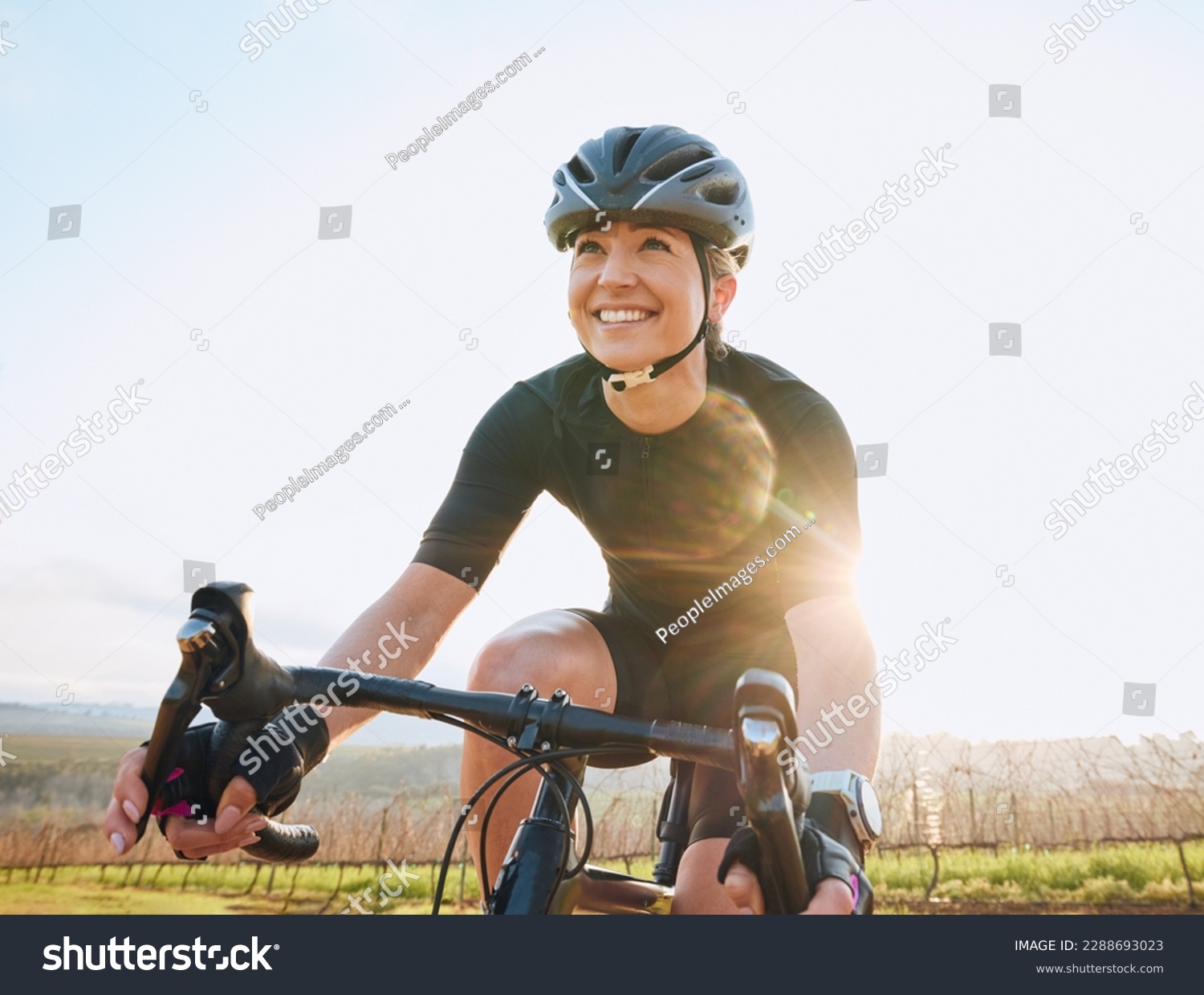 Cycling, fitness and happy with woman in park for training, workout and cardio health. Exercise, travel and freedom with female cyclist riding on bike in nature for adventure, journey and transport #2288693023