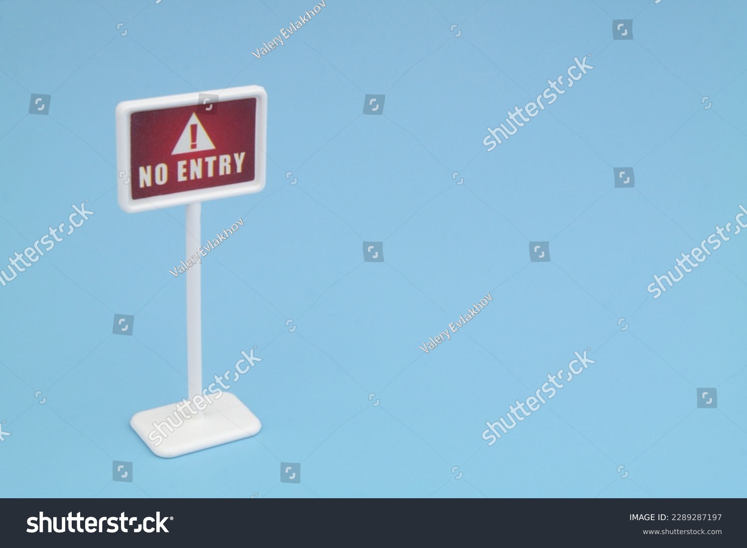 No entry warning sign on blue background with space for text. #2289287197