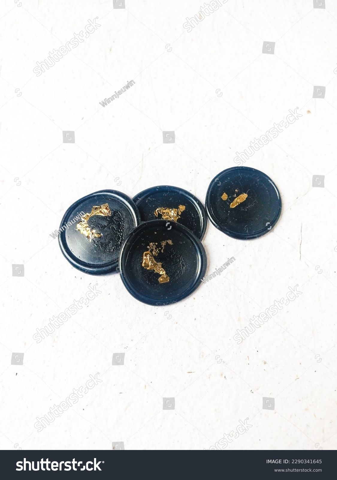 A bunch of black with gold foil blank pattern wax stamp or wax seal coins on a white background. Can be use for vintage antique wedding invitation or decoration #2290341645