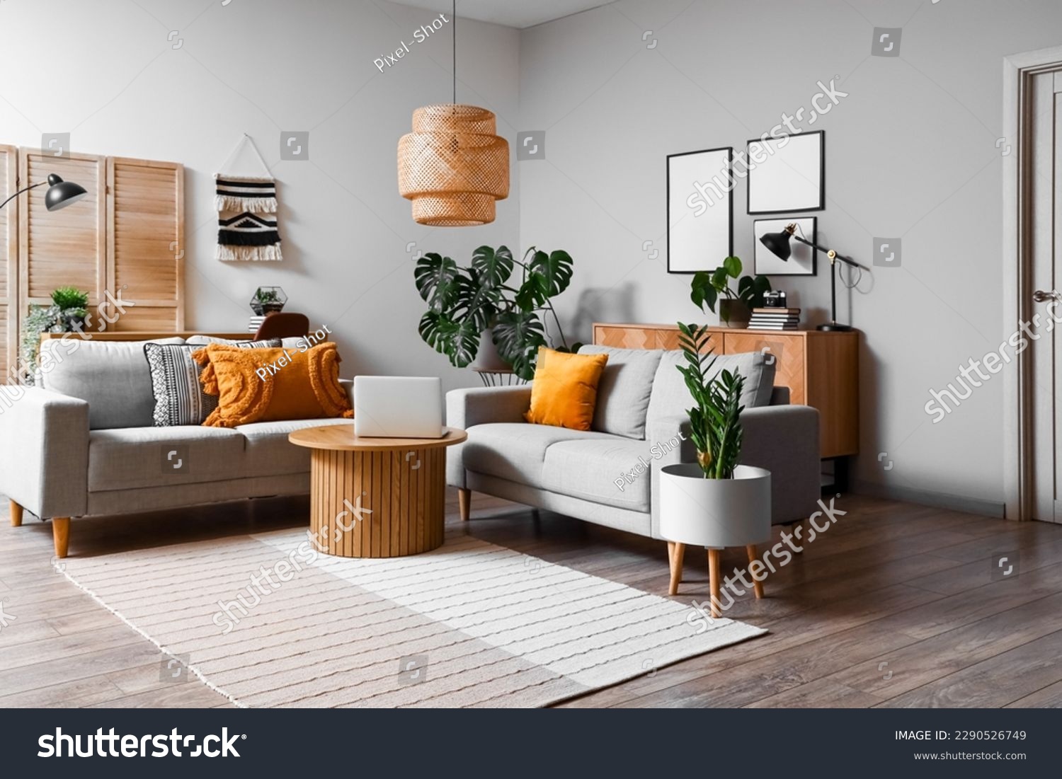 Interior of living room with green houseplants and sofas #2290526749