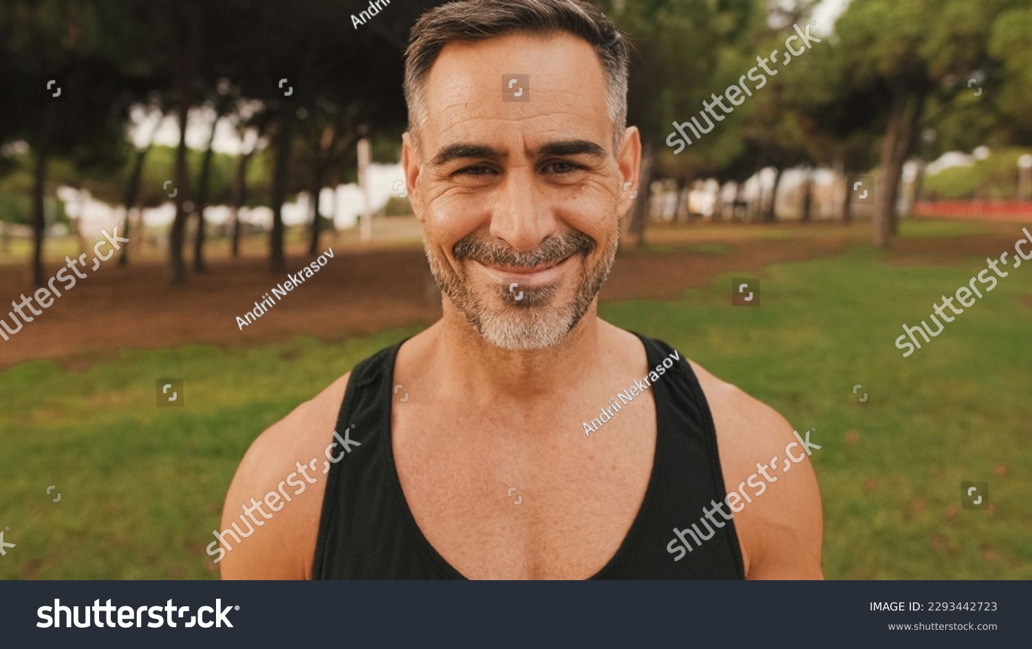 Close-up happy mature muscular man in sportswear looking at camera and smiling #2293442723