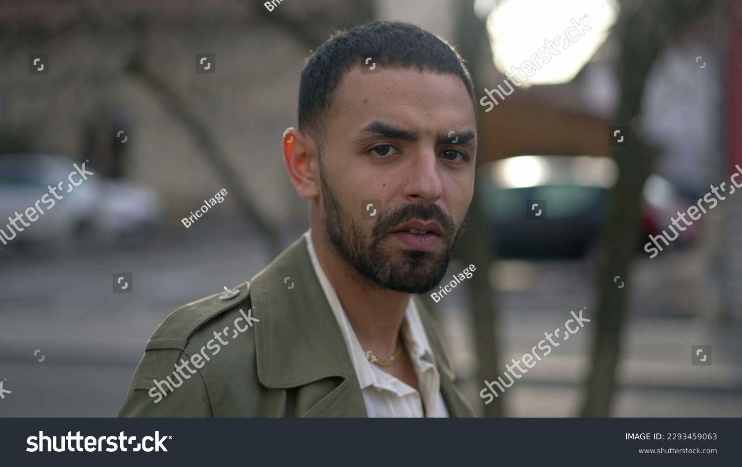 Portrait face of a Middle Eastern young man with serious expression staring at camera #2293459063