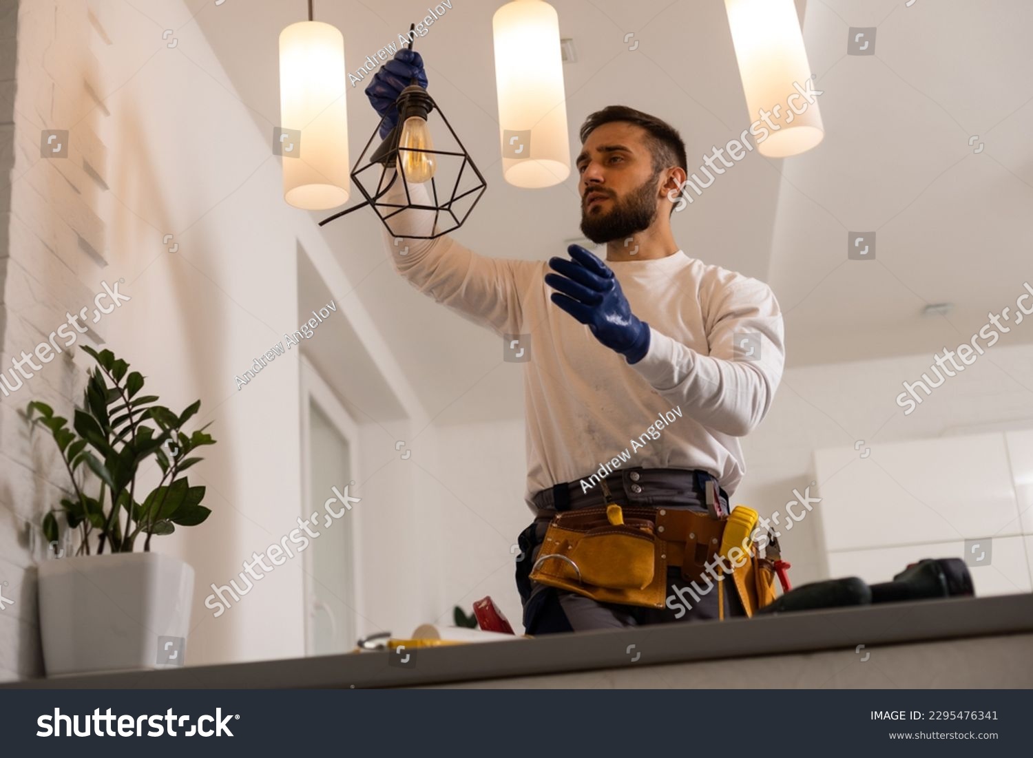 electrician installing led light bulbs in ceiling lamp #2295476341