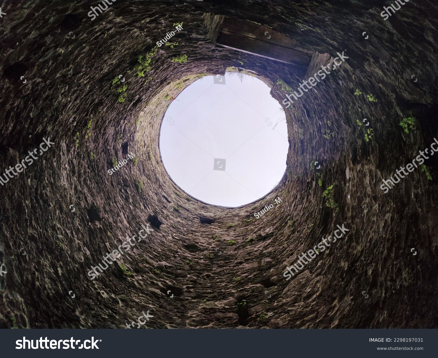 Stone well hole, old construction from inside, fall down in the well #2298197031