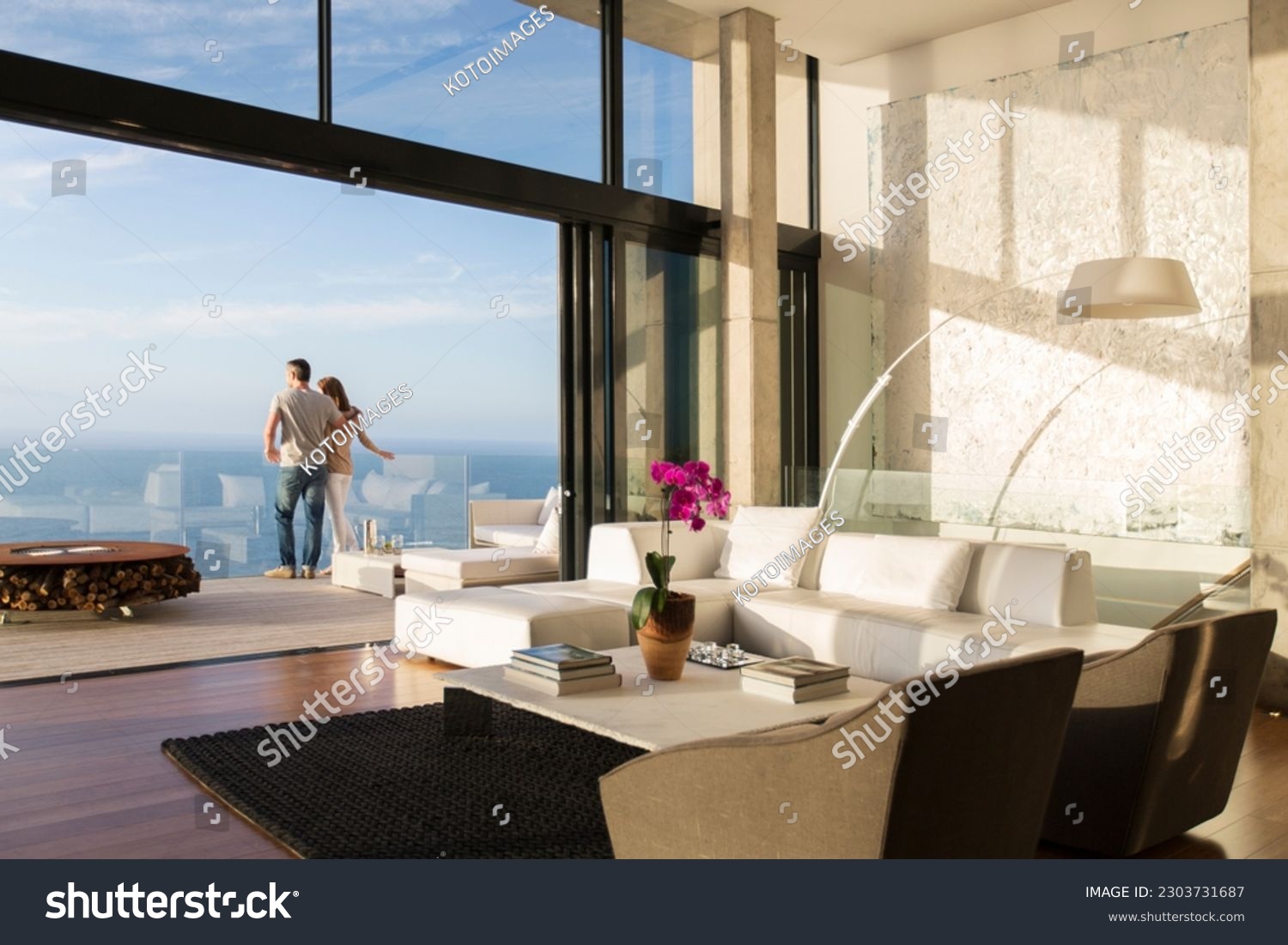 Couple standing on balcony of modern house #2303731687