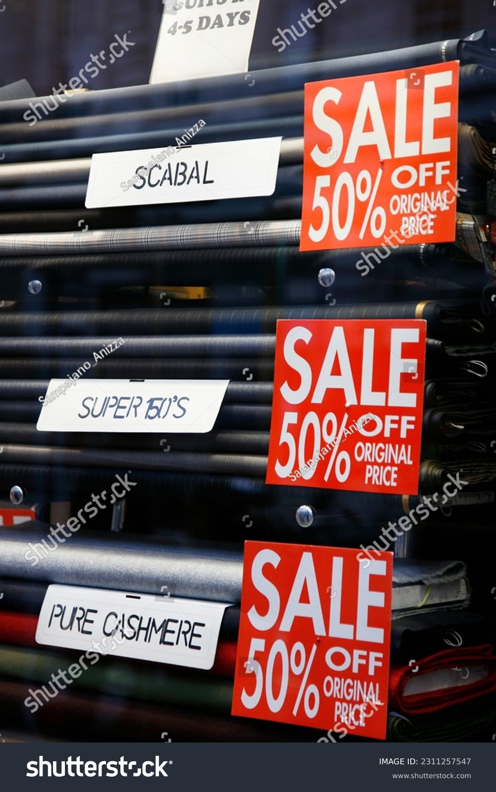 Sale signs in shop window, big reductions #2311257547