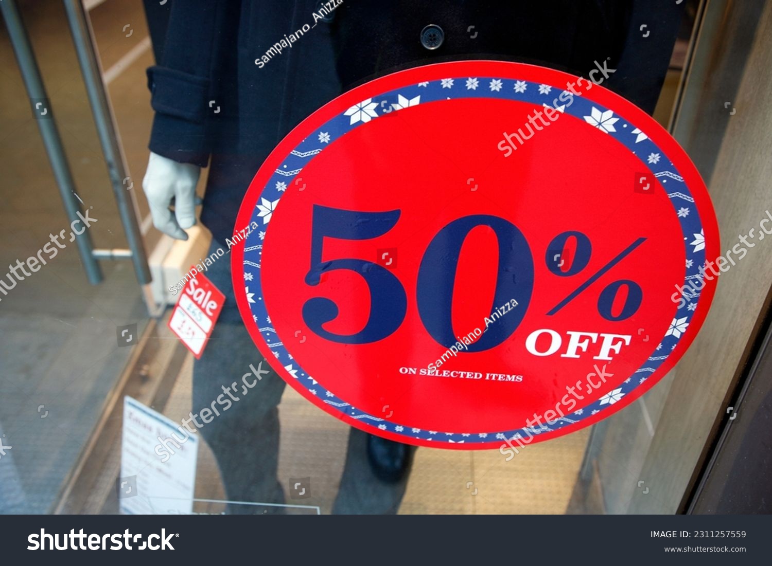 Sale signs in shop window, big reductions #2311257559