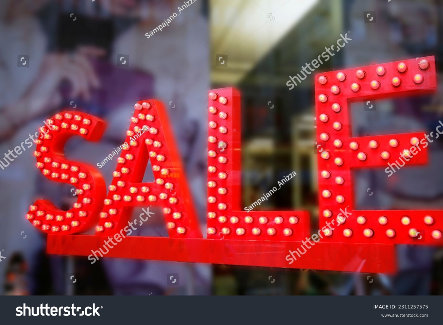 Sale signs in shop window, big reductions #2311257575