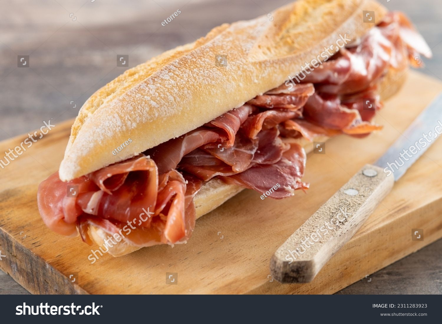 Spanish serrano ham sandwich on wooden table #2311283923