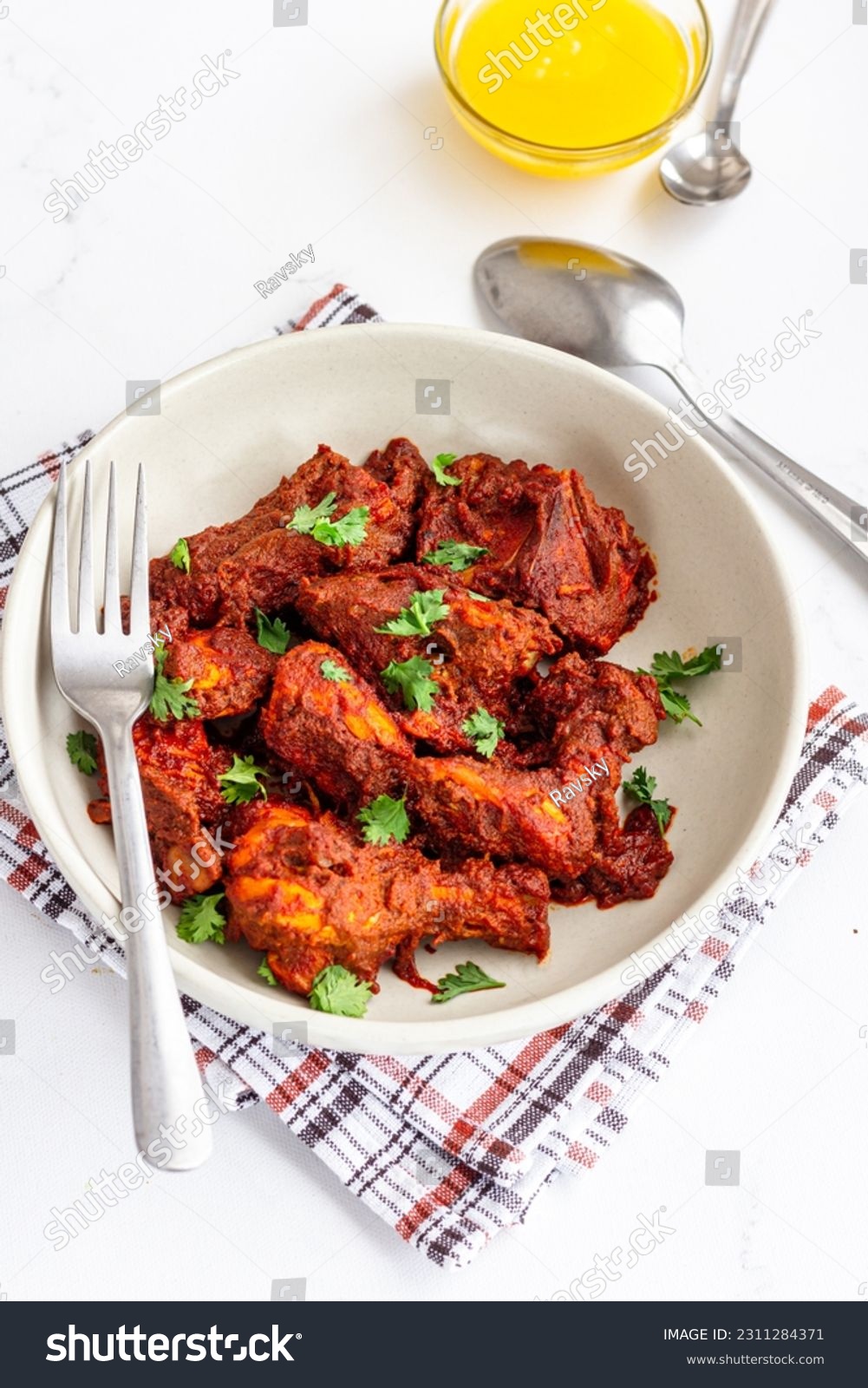 Spicy Indian Stir-Fried Chicken in a Bowl Top Down Photo on White Background Vertical Photo #2311284371