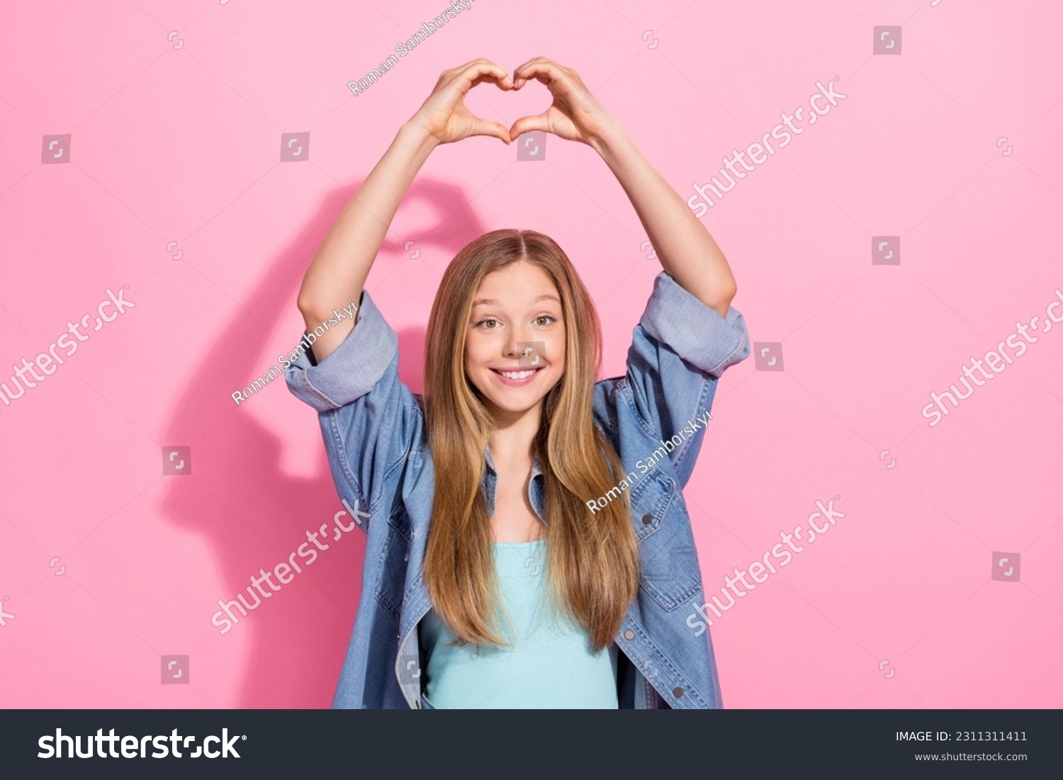 Photo portrait of lovely young teenager lady raise hands heart shape gesture wear trendy jeans garment isolated on pink color background #2311311411