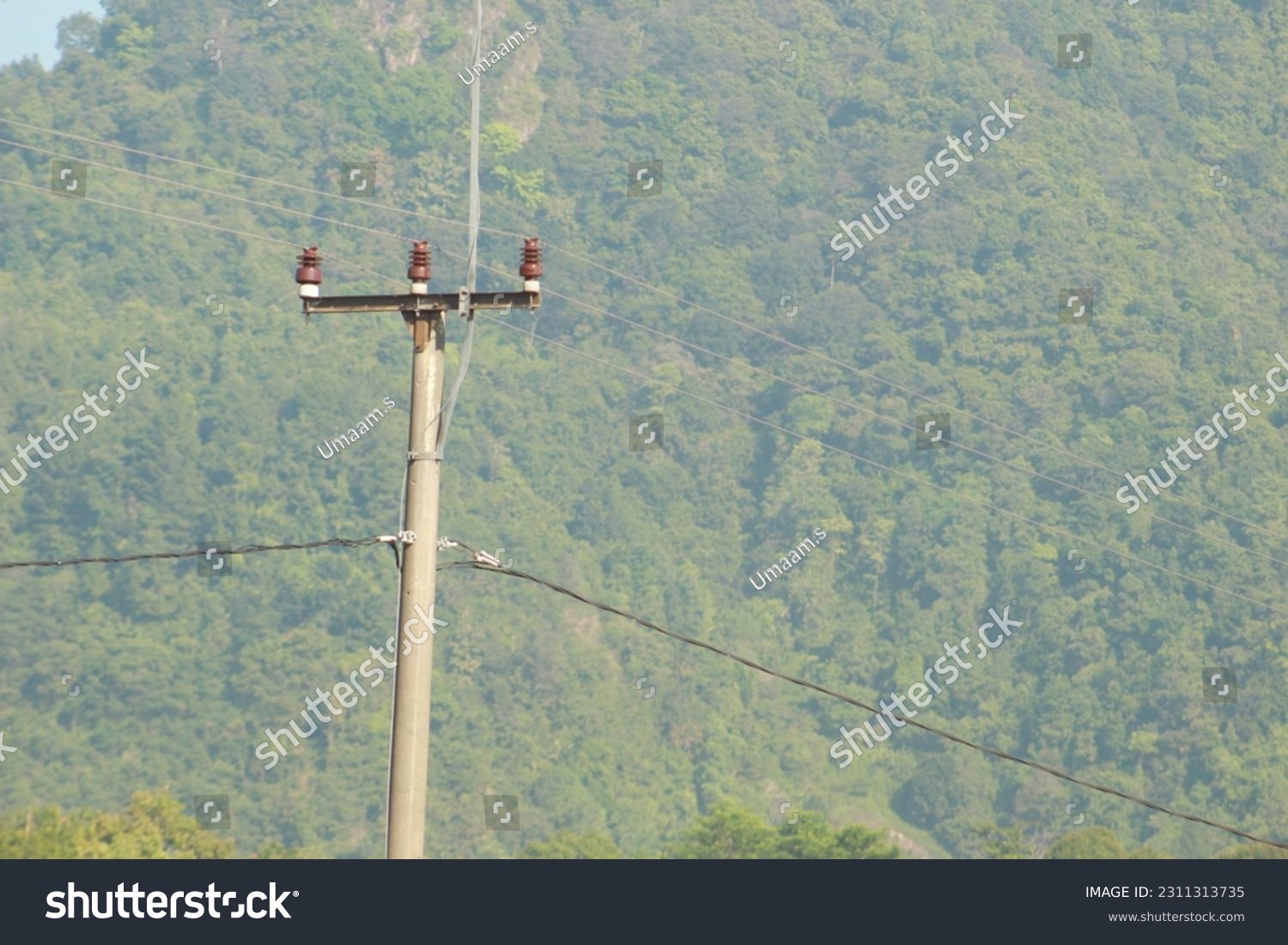 electricity pole with very green hills background in indonesia #2311313735