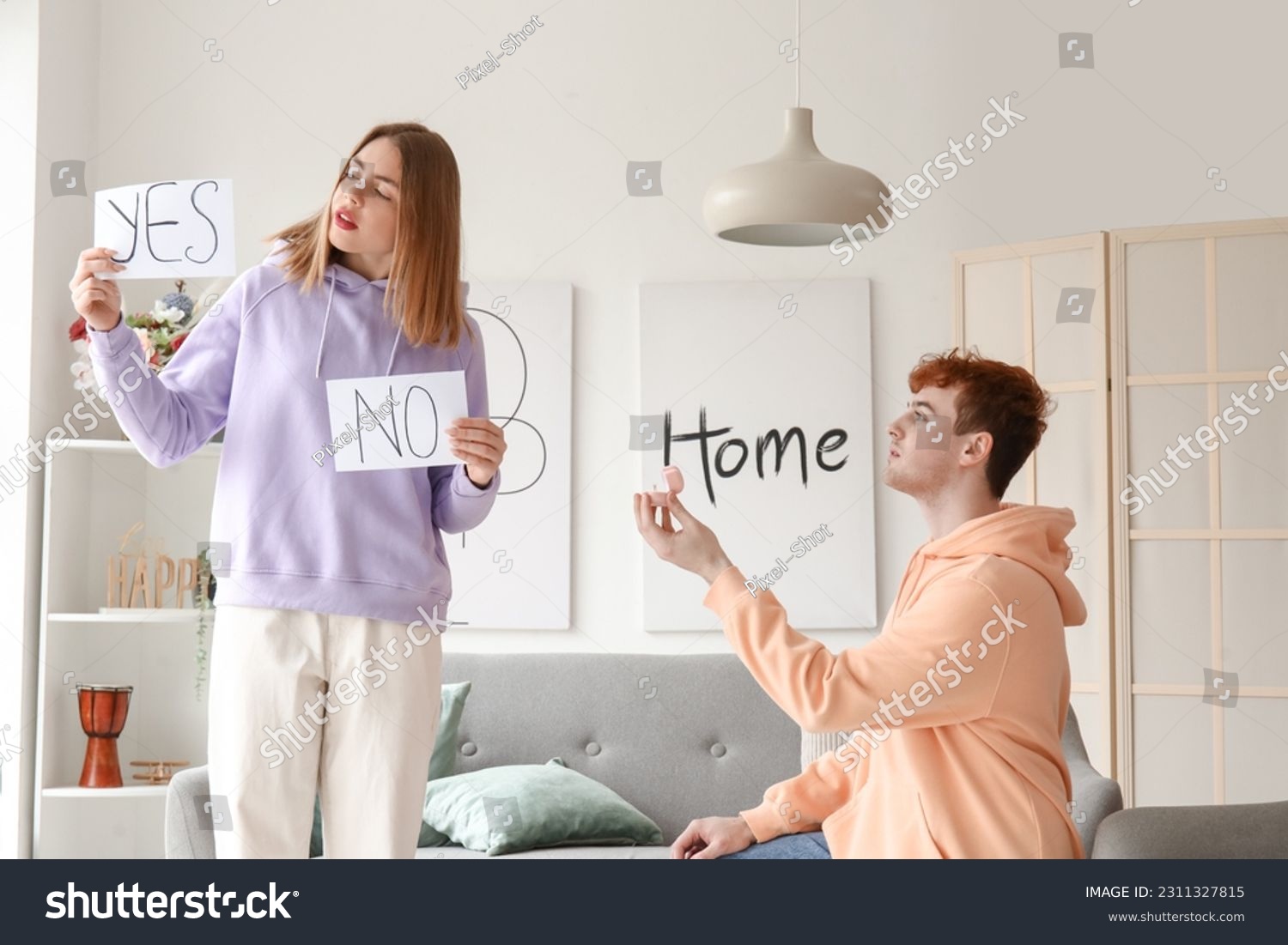 Young man proposing to his hesitating girlfriend at home #2311327815