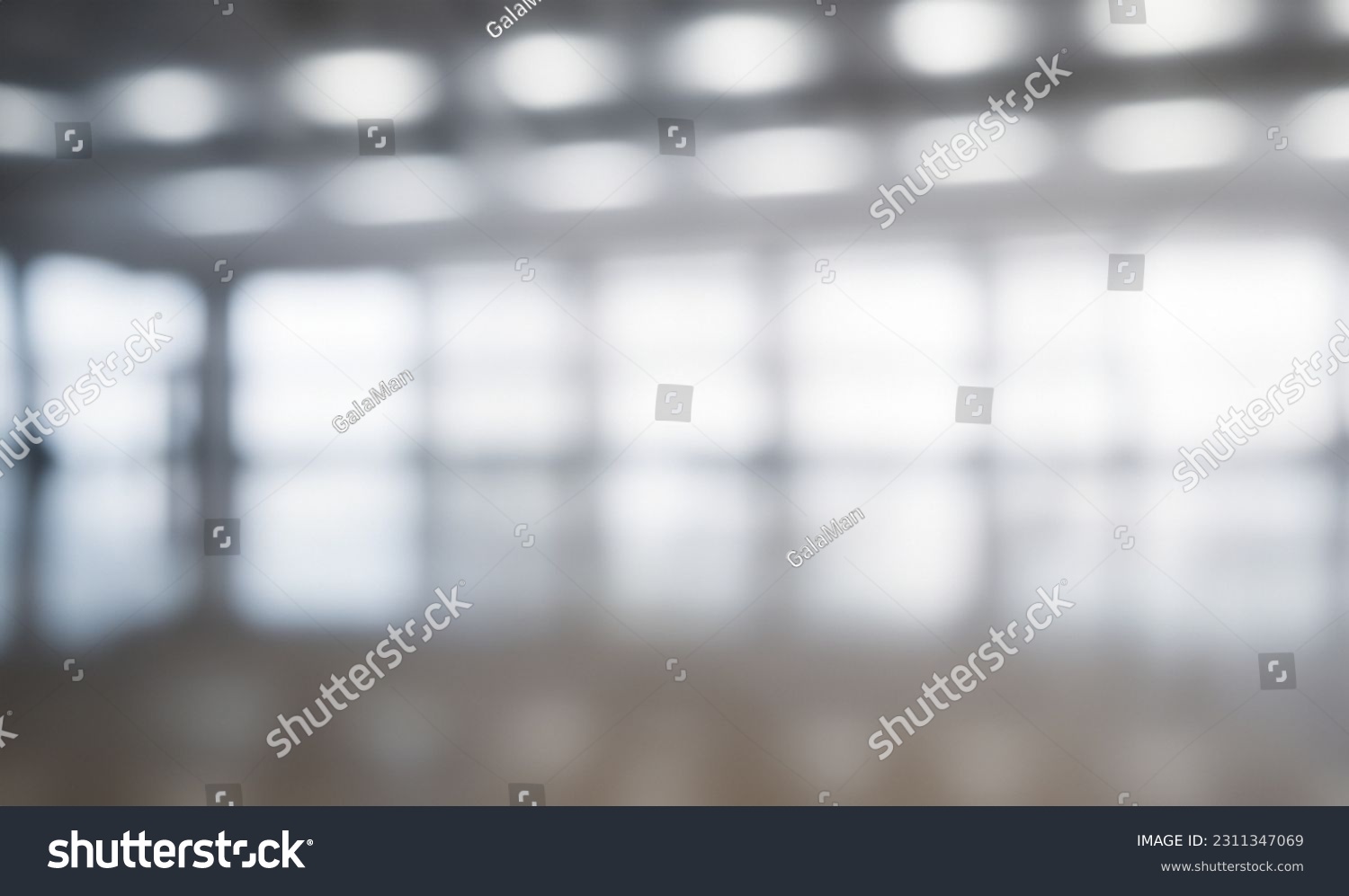 Blurred empty open space office. Abstract light bokeh at office interior background for design and table #2311347069