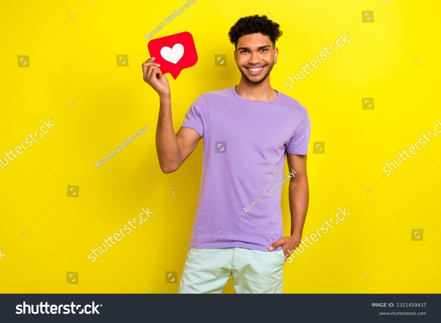 Portrait of positive young man toothy smile hand hold paper like notification card isolated on yellow color background #2311459437